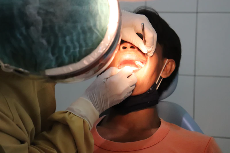 A dentist filling a cavity under a bright light